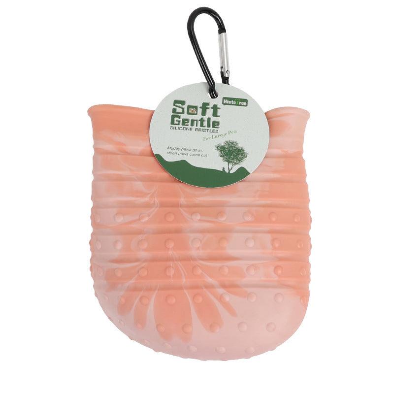 Soft silicone dog paw cleaner cup in light pink color, designed for easy pet foot cleaning and grooming.